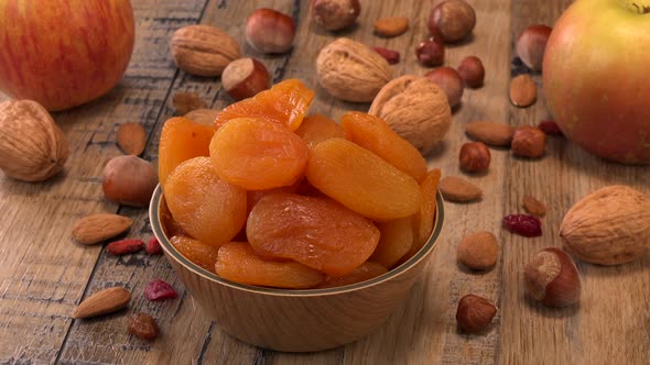 Dried fruit cand apple omposition on wood background