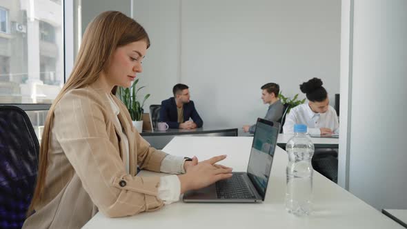 Businesswoman Using Laptop in Open Space Office