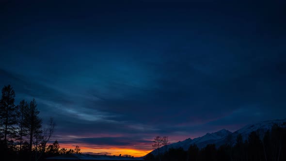 Beautiful time lapse of the nightfall at the mountains. Amazing sunset and sky