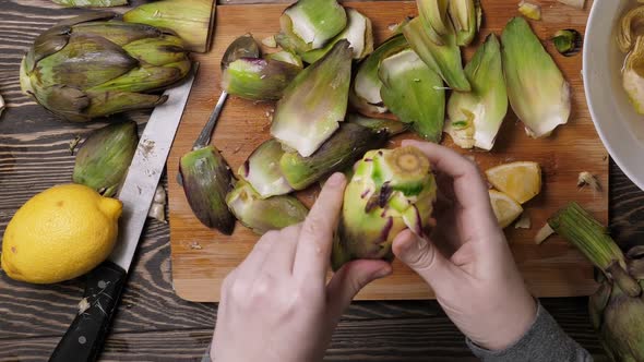 Woman Cleaning Artichokes