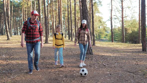 Happy Family Hiking Through a Forest