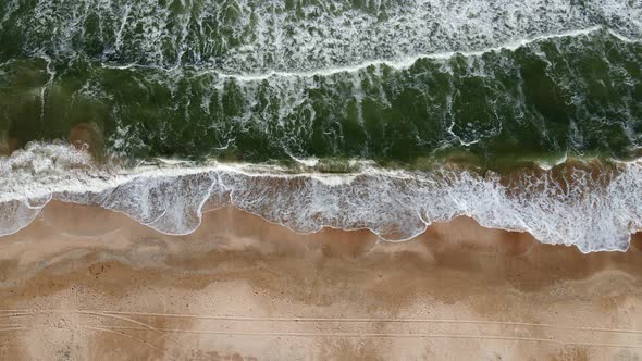 Drone Flight Over the Azure Sea with Waves and Sandy Coast