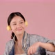 Happy pretty Asian teenager girl dancing and listening music by smartphone on pink background. - VideoHive Item for Sale