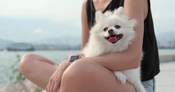 Woman hugging her dog at outdoor