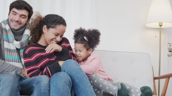 happiness caucasian and latin family play tickle together