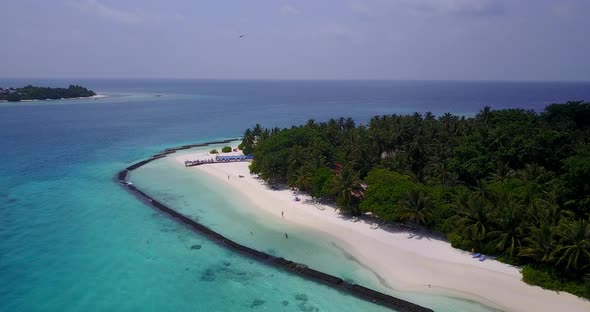 Beautiful above tourism shot of a paradise sunny white sand beach and blue ocean background in color