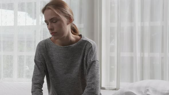 Young caucasian woman is depression and having mental problem in the bedroom at home.