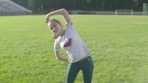 Girl Athlete Doing Gymnastics in the Stadium. Slow Motion