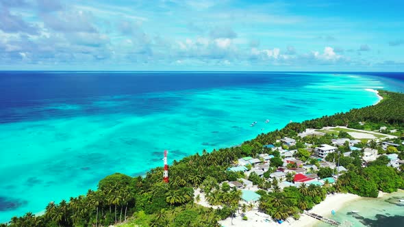 Natural flying abstract view of a white sand paradise beach and blue ocean background in vibrant 4K