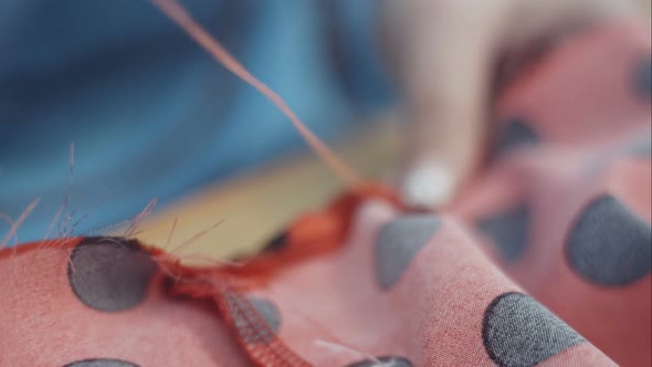 Closeup Hands of Seamstress at Work with Cloth Fabric