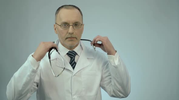 Professional Therapist Putting Stethoscope Around Neck, Ready to Examine Patient