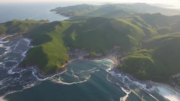 Drone View of the Sea Coast with Blue Water and Rocky Headlands at Sunset