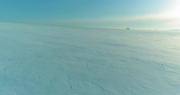 Aerial View of Cold Winter Landscape Arctic Field Trees Covered with Frost Snow Ice River and Sun