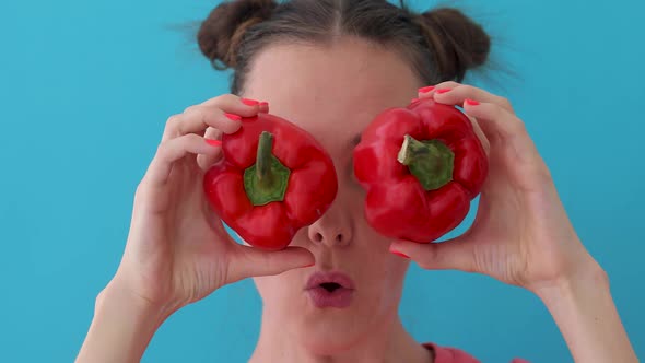 Woman Holds Pepper in Her Hands Like Eyes