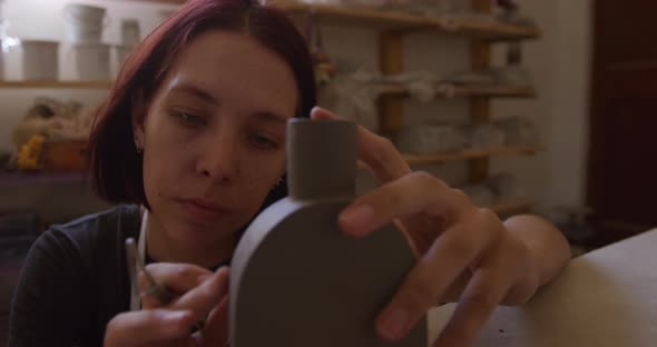 Young female potter working in her studio