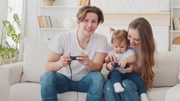 Young Family Play Online Video Game Sitting at Home Couch Quarantine Leisure Caring Fun Parents Mom