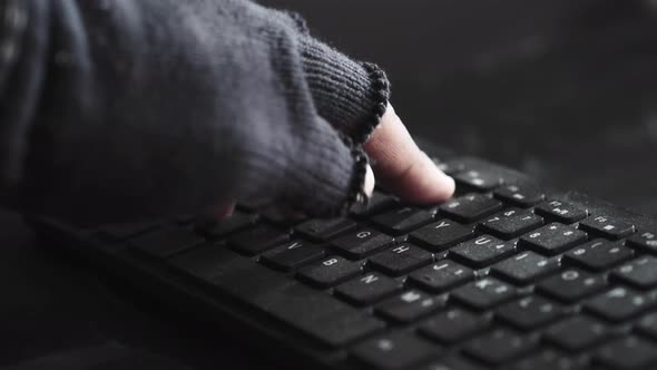Hacker Hand Stealing Data From Laptop Top Down