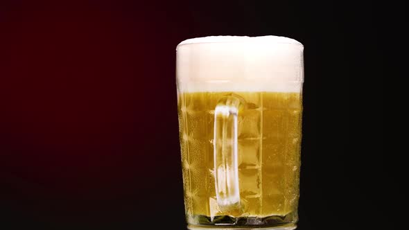 Beer glass on gradiental red background