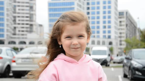 Little Beautiful Girl Portrait Eating a Bar of Chocolate