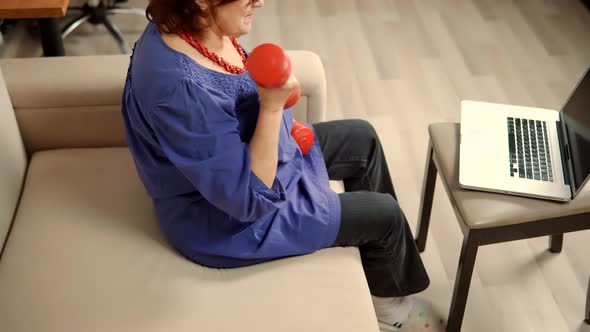 Mature Sport Exercises. Senior Woman Lifting Weight. Old Lady Exercising At Home To Stay Fit.