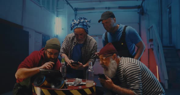 Men with Smartphones Watching Match on Tablet and Celebrating Victory