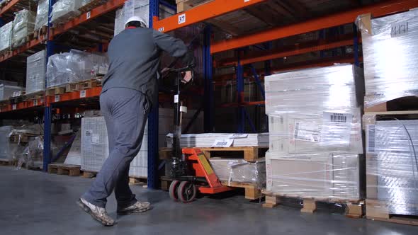 Warehouse Worker Puts Pallets