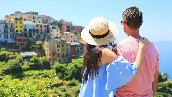 Happy Couple with View of the Old Coastal Village Background of Corniglia, Cinque Terre National
