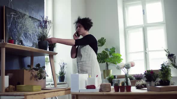 Florist discussing order with client on the phone