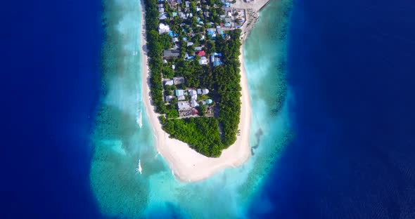 Wide drone travel shot of a white sand paradise beach and aqua blue ocean background in hi res 4K