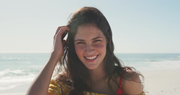 Caucasian woman looking at camera at beach