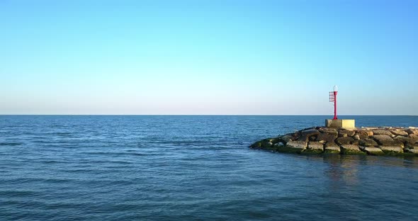 Overflight Above the Sea and a Stone Dam