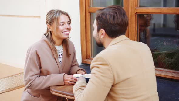 Lovely couple drinking tea and kissing in cafe