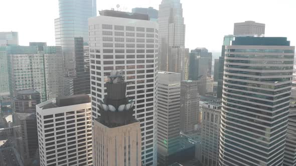 Aerial footage of downtown Minneapolis during a sunny afternoon, crossing by the buildings