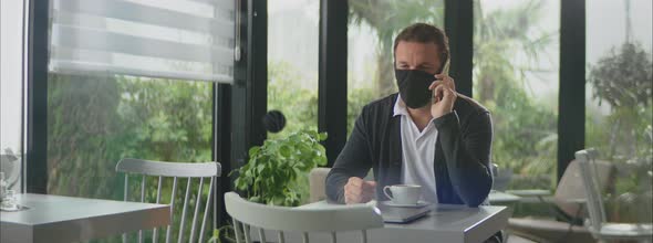 Man with face mask having call