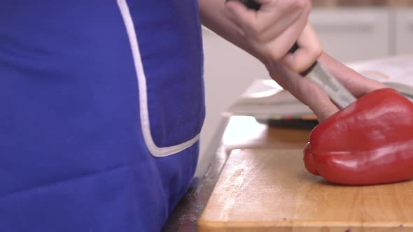 Cutting red bell pepper in half