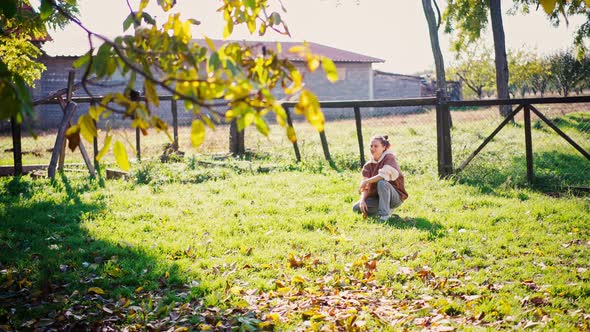 A Young Woman Plays a Ball with Her Two Cute Dogs