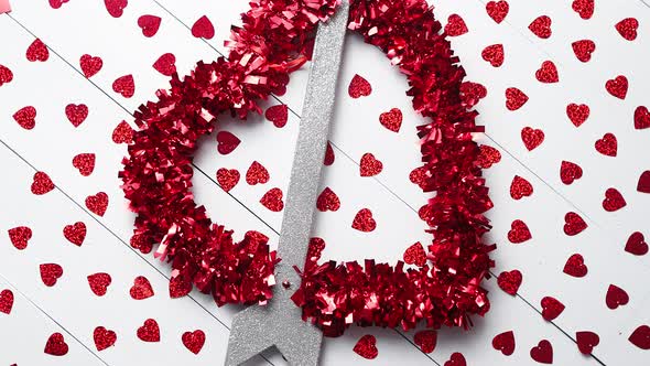 Valentine's Day Composition. Heart Shaped Sequins Placed on White Wooden Table