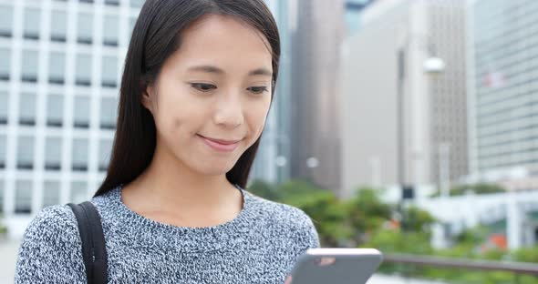 Woman use of smart phone in city