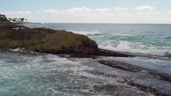 Waves crashing over Oahu's the volcanic rocks.