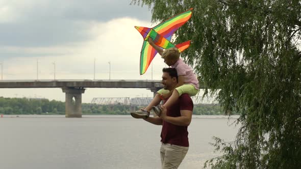 Father and Son Launching Kite Near River, Happy Time Together, Parents Love