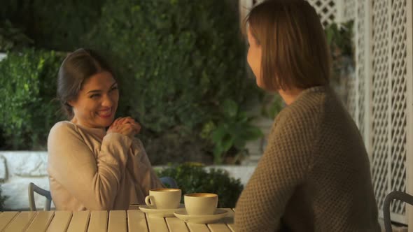 Excited Female Discussing With Sister Upcoming Marriage, Sitting on Terrace