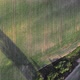 Aerial Drone Top Down View of Small Heart Shaped Copse with Shadows on a Freshly Sown Green Field - VideoHive Item for Sale