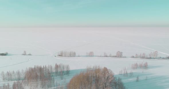 Aerial View of Cold Winter Landscape Arctic Field Trees Covered with Frost Snow Ice River and Sun