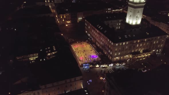 Arial View of City Lviv Ukraine Rynok Square Christmas Fair People Skate on Ice Skating Rink