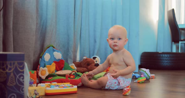 Cute Little Baby Playing with Toys in the Room