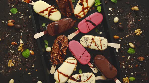 Set of Delicious White and Milk Chocolate and Strawberry Ice Cream on a Stick Served in Metal Tray