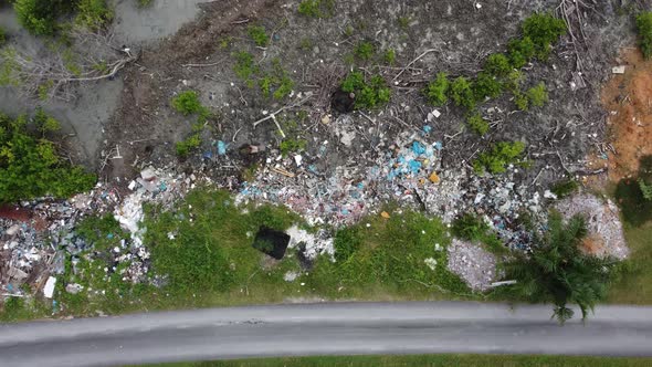 Aerial look down rubbish beside road