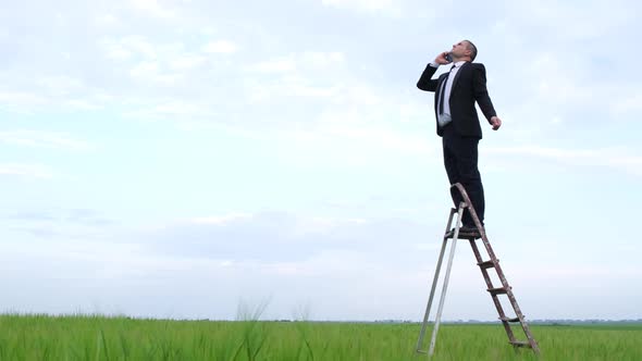 A Man Catches a Mobile Network in an Open Field