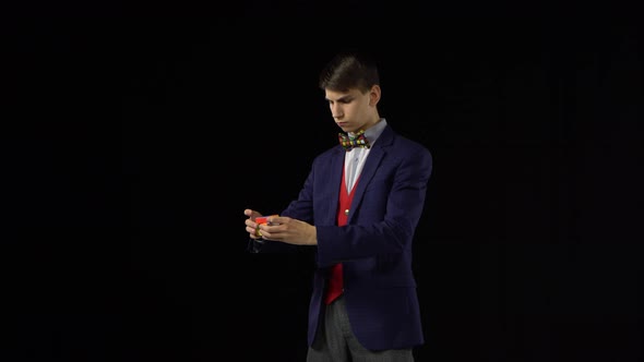 Smart Boy in Suit Is Solving Rubik's Cube in Dark.