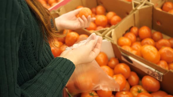 Faceless Girl in a Supermarket Selects the Vegetable